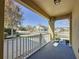 Inviting front porch with white railing, offering neighborhood views on a sunny day at 6826 Goldflower Ave, Harmony, FL 34773