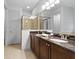 Double vanity bathroom with granite counters at 7617 Wilmington Loop, Kissimmee, FL 34747