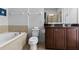 Bathroom with bathtub, toilet and double vanity at 7617 Wilmington Loop, Kissimmee, FL 34747