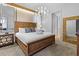 Large bedroom with a king-size bed and a chandelier at 7617 Wilmington Loop, Kissimmee, FL 34747