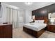 Bedroom with a king-size bed and dark-colored wall at 7617 Wilmington Loop, Kissimmee, FL 34747