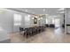 Large dining room with long wooden table and grey chairs at 7617 Wilmington Loop, Kissimmee, FL 34747