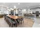 Open concept dining room with long table and kitchen access at 7617 Wilmington Loop, Kissimmee, FL 34747