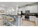 Modern kitchen with white cabinets, granite counters, and island at 7617 Wilmington Loop, Kissimmee, FL 34747