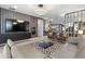 Spacious living room with modern furniture, a large TV, and hardwood floors at 7617 Wilmington Loop, Kissimmee, FL 34747