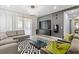 Modern living room with sectional sofa, glass coffee table, and stylish decor at 7617 Wilmington Loop, Kissimmee, FL 34747