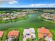 Bird's-eye view of lakefront homes with lush landscaping at 870 Spinnaker Way, Kissimmee, FL 34746