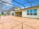 Spacious backyard with covered patio and brick pavers at 870 Spinnaker Way, Kissimmee, FL 34746