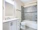 Clean bathroom, white vanity, and grey tile shower/tub combo at 870 Spinnaker Way, Kissimmee, FL 34746