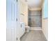Clean bathroom with grey tile shower and white vanity at 870 Spinnaker Way, Kissimmee, FL 34746
