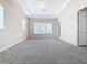 Large bedroom with carpet, neutral walls and large windows at 870 Spinnaker Way, Kissimmee, FL 34746