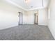 Spacious bedroom with carpet flooring and multiple doors at 870 Spinnaker Way, Kissimmee, FL 34746