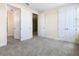 Spacious bedroom with carpet flooring and multiple closets at 870 Spinnaker Way, Kissimmee, FL 34746