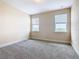 Bright bedroom with neutral carpeting and two windows at 870 Spinnaker Way, Kissimmee, FL 34746