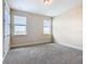 Bright bedroom with neutral carpeting and two windows at 870 Spinnaker Way, Kissimmee, FL 34746