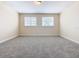 Bright bedroom featuring neutral walls and carpet at 870 Spinnaker Way, Kissimmee, FL 34746