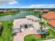 Two-story house with tile roof, large windows, and a brick driveway at 870 Spinnaker Way, Kissimmee, FL 34746