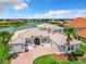 Two-story house with tile roof, large windows, and a brick driveway at 870 Spinnaker Way, Kissimmee, FL 34746