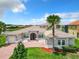 Two-story house with tile roof, large windows, and a brick driveway at 870 Spinnaker Way, Kissimmee, FL 34746