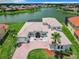 Two-story house with tile roof, large windows, and a brick driveway at 870 Spinnaker Way, Kissimmee, FL 34746