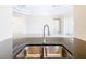 Double stainless steel sink with gooseneck faucet in a modern kitchen at 870 Spinnaker Way, Kissimmee, FL 34746