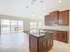 Island kitchen with dark wood cabinets, granite countertops and stainless steel appliances at 870 Spinnaker Way, Kissimmee, FL 34746