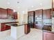 Modern kitchen with dark wood cabinets, granite counters, and stainless steel appliances at 870 Spinnaker Way, Kissimmee, FL 34746