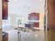 Modern kitchen with dark wood cabinets and granite counters at 870 Spinnaker Way, Kissimmee, FL 34746