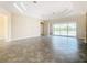 Spacious living room with sliders opening to a lake view at 870 Spinnaker Way, Kissimmee, FL 34746