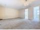Spacious loft area with neutral carpeting and chandelier at 870 Spinnaker Way, Kissimmee, FL 34746