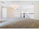 Spacious loft area with neutral carpeting and chandelier at 870 Spinnaker Way, Kissimmee, FL 34746
