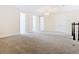Spacious loft area with neutral carpeting and chandelier at 870 Spinnaker Way, Kissimmee, FL 34746
