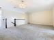 Spacious loft area with neutral carpeting and chandelier at 870 Spinnaker Way, Kissimmee, FL 34746