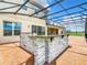 Outdoor kitchen with stone facade and covered patio at 870 Spinnaker Way, Kissimmee, FL 34746