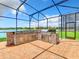 Outdoor kitchen with grill and stone countertops at 870 Spinnaker Way, Kissimmee, FL 34746