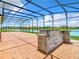 Large brick paver patio with outdoor kitchen and lake view at 870 Spinnaker Way, Kissimmee, FL 34746