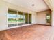 Covered patio with sliding glass doors and lake view at 870 Spinnaker Way, Kissimmee, FL 34746