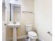 Small powder room with pedestal sink and toilet at 870 Spinnaker Way, Kissimmee, FL 34746