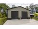 Two-car garage with brown roll-up doors at 875 Eden Dr, St Cloud, FL 34771
