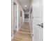 Bright hallway with light wood floors and wall art at 875 Eden Dr, St Cloud, FL 34771