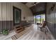 Rustic screened porch with wood flooring and rocking chair at 875 Eden Dr, St Cloud, FL 34771