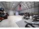 Spacious workshop with high ceilings, large roll-up door, and ample storage at 875 Eden Dr, St Cloud, FL 34771