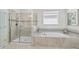 Elegant bathroom with a large shower and soaking tub at 8870 Backspin Ln, Champions Gate, FL 33896