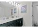 Double vanity bathroom with modern dark cabinets and a shower at 8870 Backspin Ln, Champions Gate, FL 33896