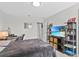 Spacious bedroom with a large TV and built-in shelving at 8870 Backspin Ln, Champions Gate, FL 33896