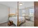 Bedroom with a four-poster bed and a sitting area at 8870 Backspin Ln, Champions Gate, FL 33896