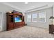 Large bonus room with wood entertainment center and carpeted floors at 8870 Backspin Ln, Champions Gate, FL 33896