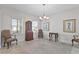 Formal dining room with chandelier and antique furniture at 8870 Backspin Ln, Champions Gate, FL 33896