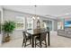 Bright dining room with a wooden table and four chairs, near sliding doors at 8870 Backspin Ln, Champions Gate, FL 33896