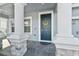 Elegant front entry with dark blue door and sunflower wreath at 8870 Backspin Ln, Champions Gate, FL 33896